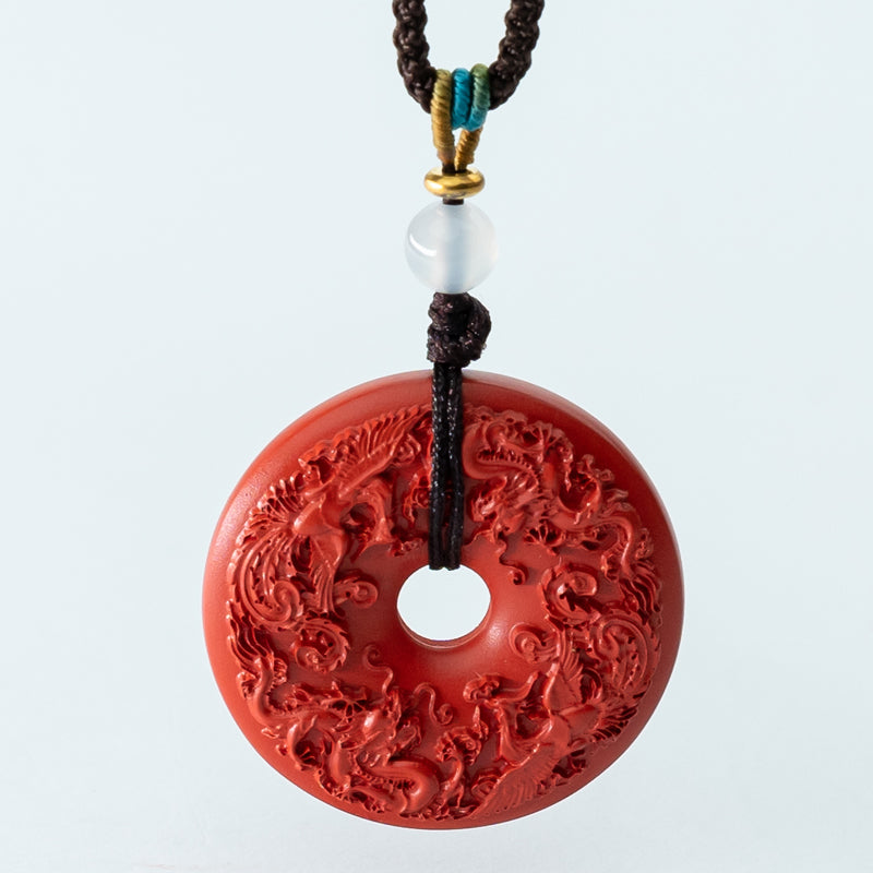 "Harmony and Prosperity: Hand-Carved Cinnabar Dragon and Phoenix Peace Pendant"