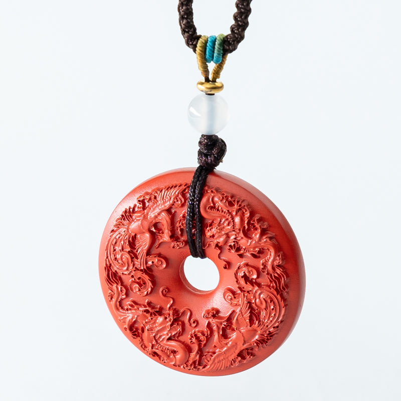 "Harmony and Prosperity: Hand-Carved Cinnabar Dragon and Phoenix Peace Pendant"