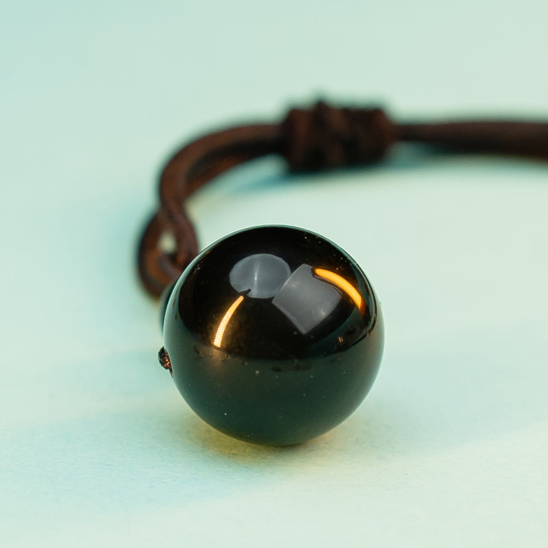 "Obsidian Bead Pendant: Symbol of Protection, Balance, and Inner Strength"