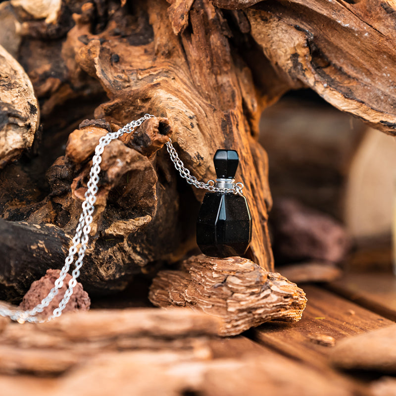 "Harmonizing Energies: The Black Obsidian and Clear Quartz Essential Oil Bottle Pendant"