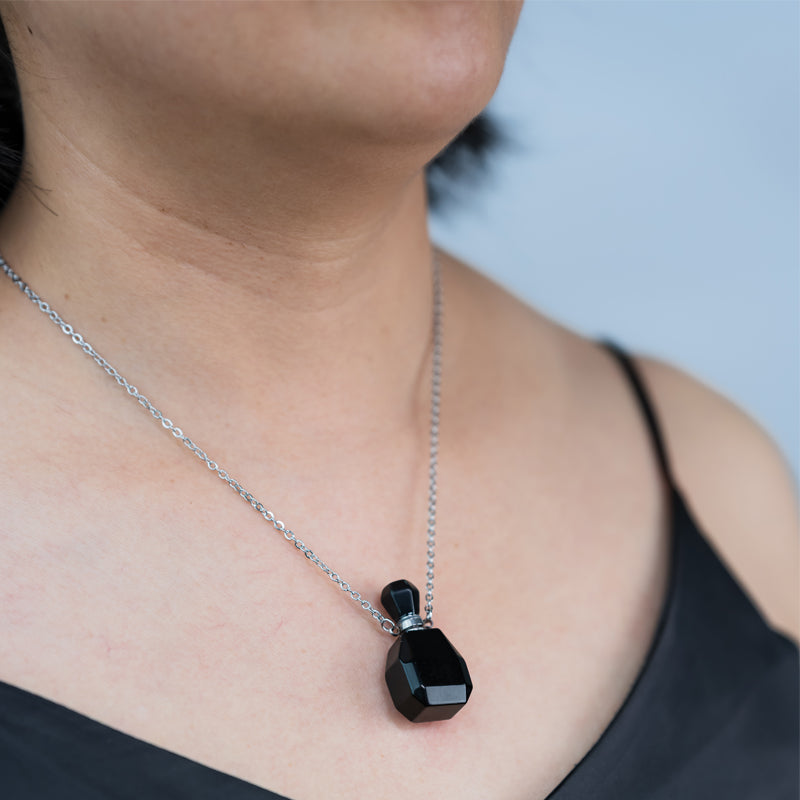 "Harmonizing Energies: The Black Obsidian and Clear Quartz Essential Oil Bottle Pendant"