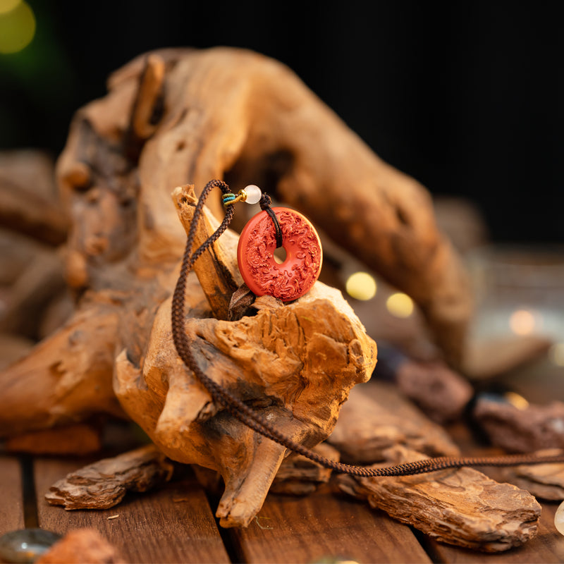 "Harmony and Prosperity: Hand-Carved Cinnabar Dragon and Phoenix Peace Pendant"