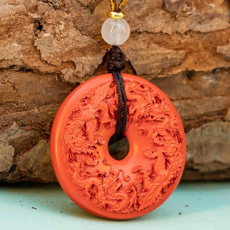 "Harmony and Prosperity: Hand-Carved Cinnabar Dragon and Phoenix Peace Pendant"