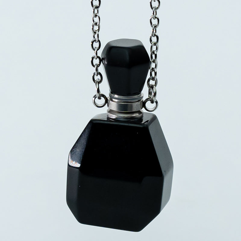 "Harmonizing Energies: The Black Obsidian and Clear Quartz Essential Oil Bottle Pendant"