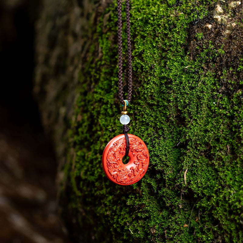 "Harmony and Prosperity: Hand-Carved Cinnabar Dragon and Phoenix Peace Pendant"