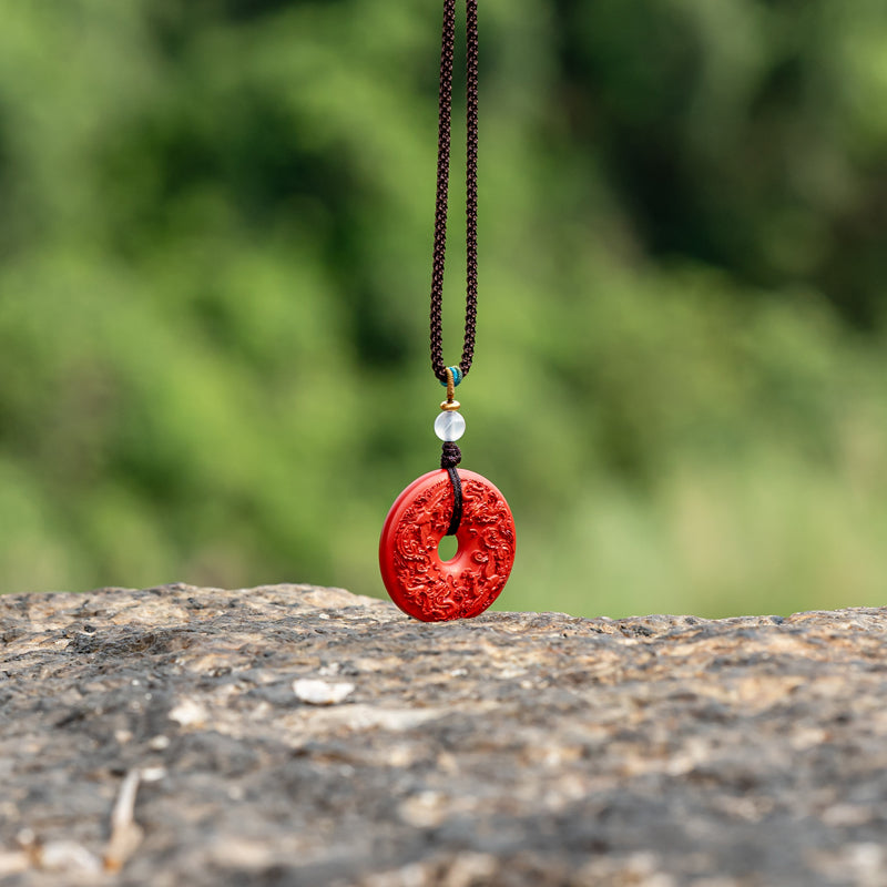 "Harmony and Prosperity: Hand-Carved Cinnabar Dragon and Phoenix Peace Pendant"